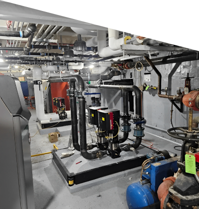 Industrial mechanical room with piping and machinery.